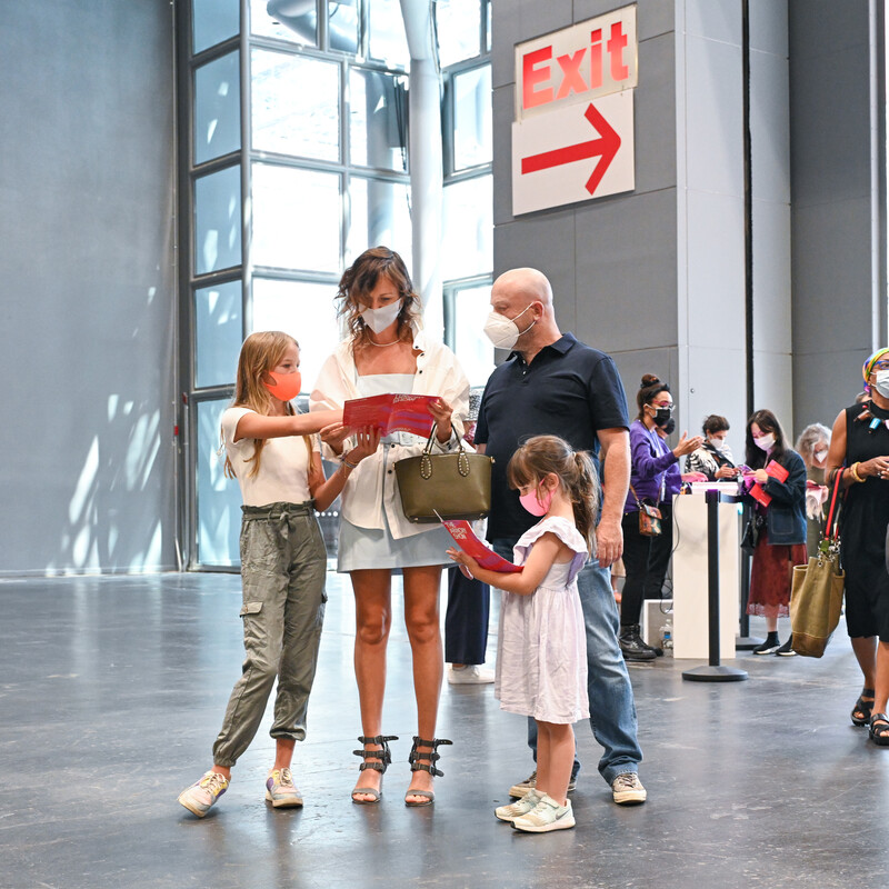 A family with two children reading The Armory Show map at the entrance of hall 3E at the Javits Center.